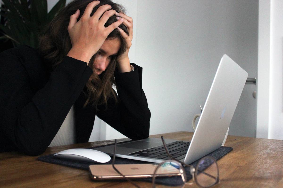 Woman looking frustrated at laptop